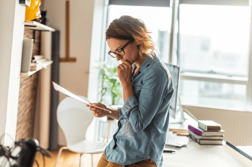woman reviewing a paper summary in a sunny room