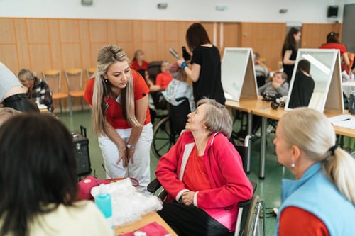 Female caregiver chatting with senior women
