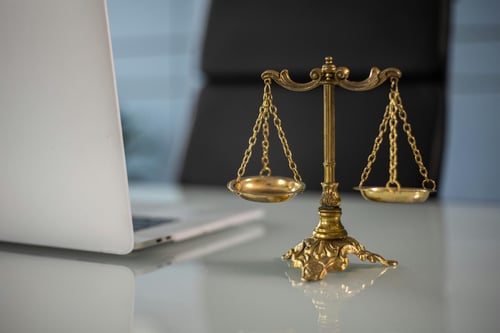Gold balance scale on desk