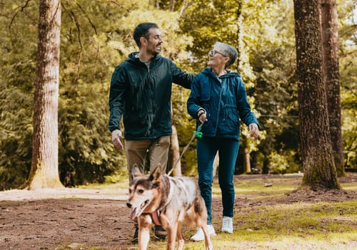 people walking dog at a park