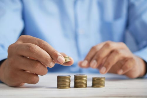 Coins staked in three rows on table