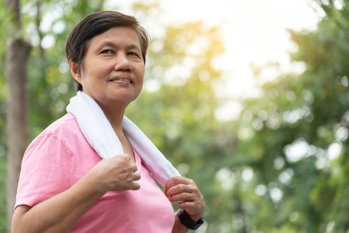 Older woman with towel around shoulders