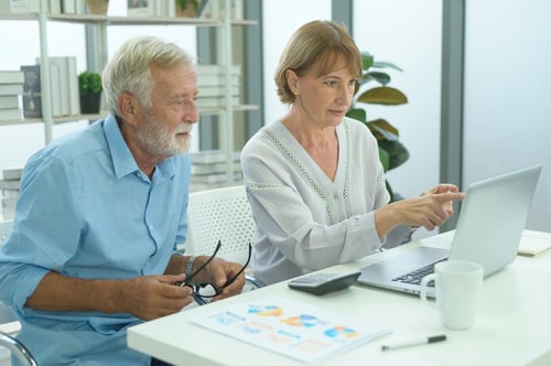 Older couple viewing something on laptop