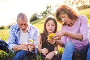 senior couple with grandaughter outside in summer
