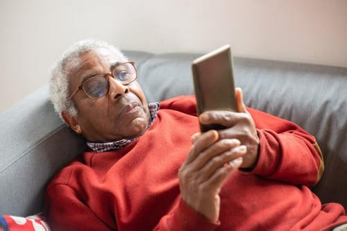senior looking at phone