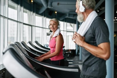 senior couple using treadmills