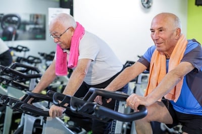 senior men on indoor bikes