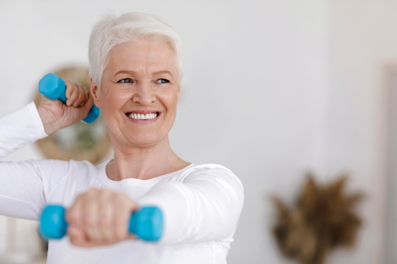 senior woman doing exercise with dumbells